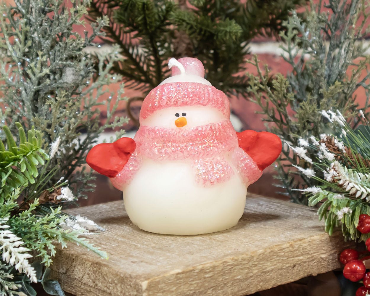 Red-hat hand-painted glitter snowman beeswax candle glowing warmly for Christmas home décor