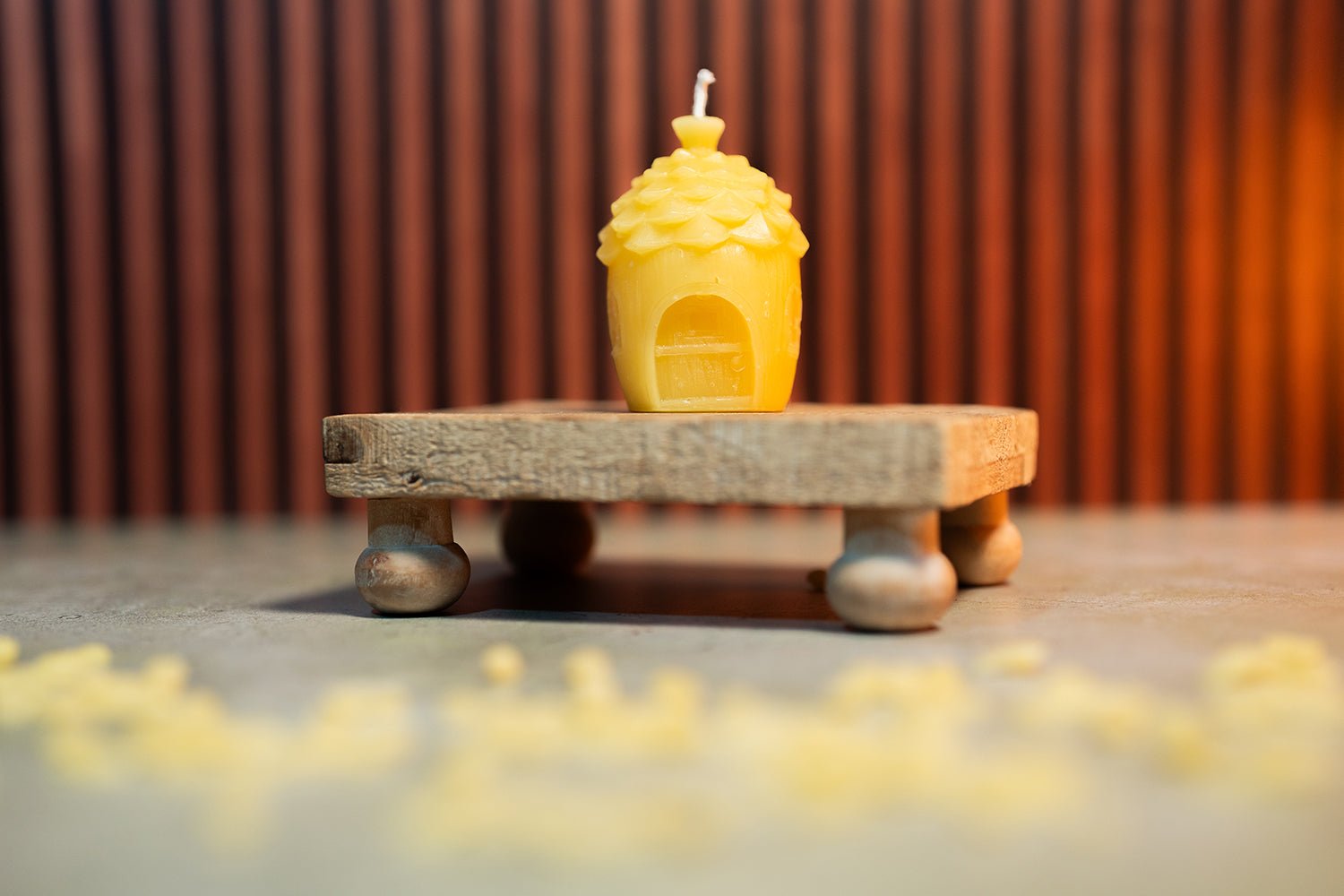 Beeswax Fairy Home candle on display with warm background lighting