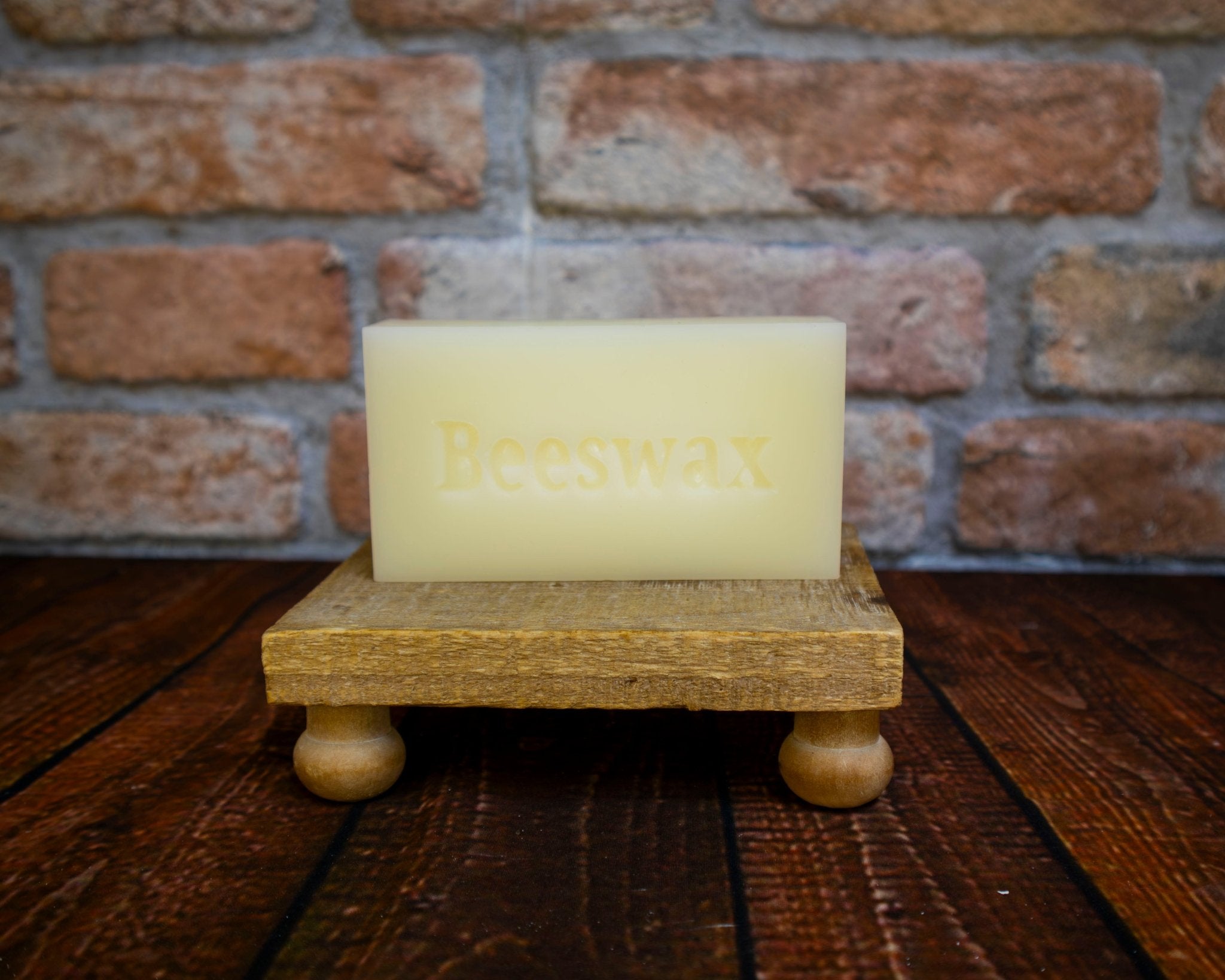 Single 1lb beeswax block on display stand natural filtered beeswax for candle making and crafts